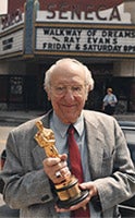 Ray Evans holding a golden trophy.